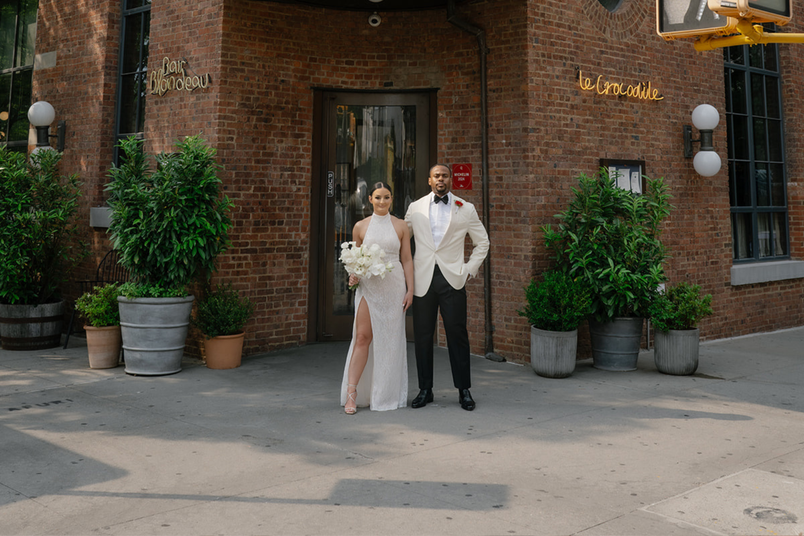 Bride and Groom posing outside in front of a brooklyn hotel