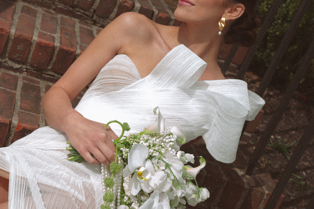 Bride in a white wedding gown holding a bouquet of flowers