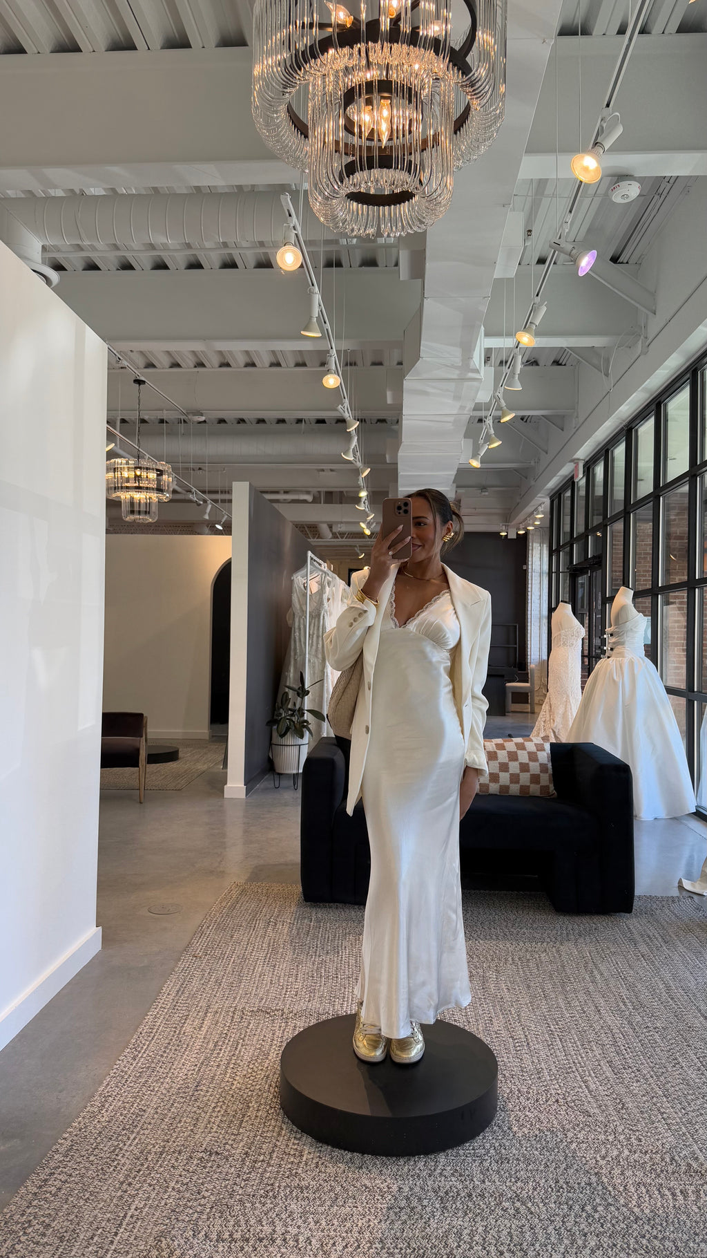 Bride wearing Amore Ivory Bridal Dress Styled with Blazer in a wedding dress boutique